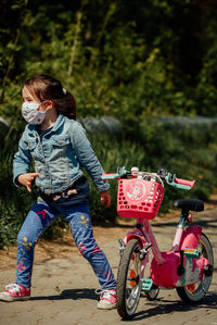 Full length of girl riding motorcycle on road