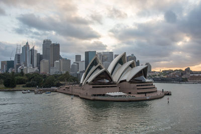 View of modern buildings in city against cloudy sky