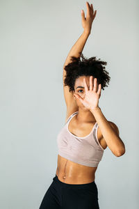 Young woman standing against white background