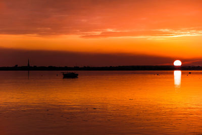 Scenic view of dramatic sky over sea during sunset