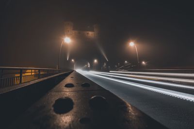 Light trails on road in city at night