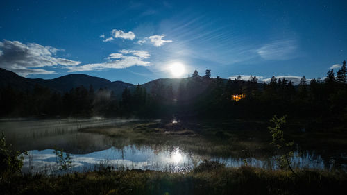 Scenic view of lake against sky at night