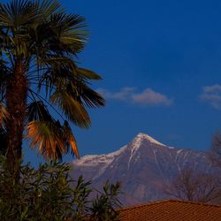 Scenic view of mountains against blue sky