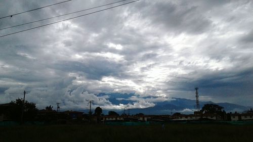 Houses by town against sky