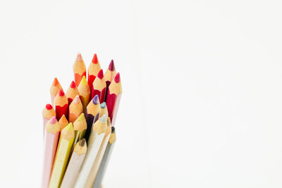 Close-up of multi colored pencils against white background