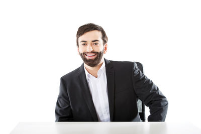 Portrait of a smiling young man against white background