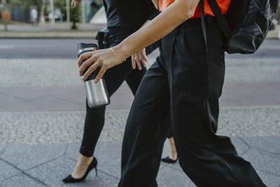 Low section of people walking on street