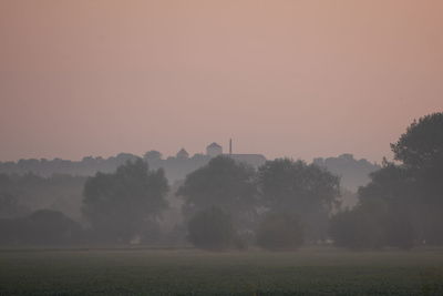 Scenic view of field against sky during sunset