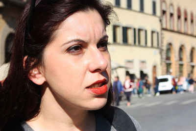 Close-up portrait of young woman looking away