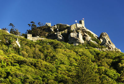 Low angle view of castle against clear blue sky