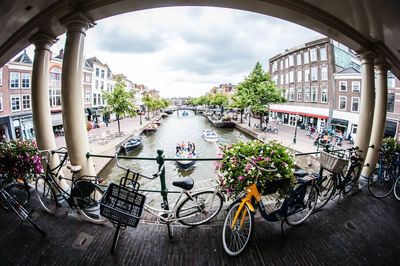 Bicycle by street against buildings in city