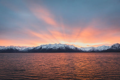 Scenic view of lake against orange sky during sunset