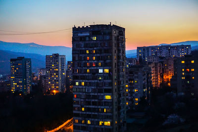 Illuminated city at sunset