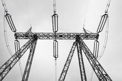 Low angle view of electricity pylon against sky