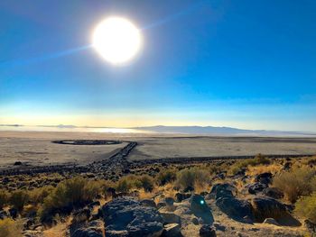 Scenic view of landscape against sky on sunny day