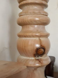 Close-up of stacked stack on table against wall