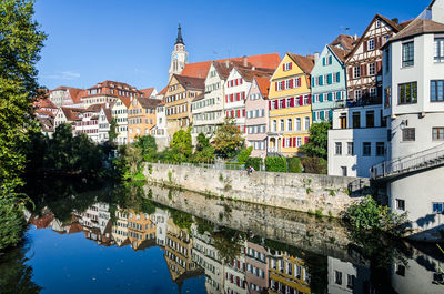 Buildings in city against blue sky