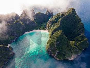 Panoramic view of rocks on sea against sky