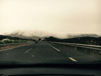 Road seen through car windshield