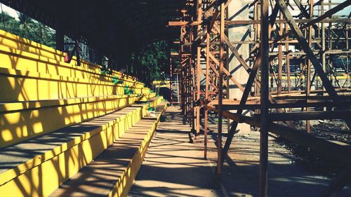 Empty steps by scaffolding on sunny day