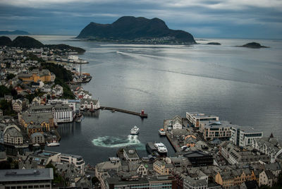 High angle view of sea by city against sky