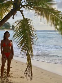 Full length of young woman on beach