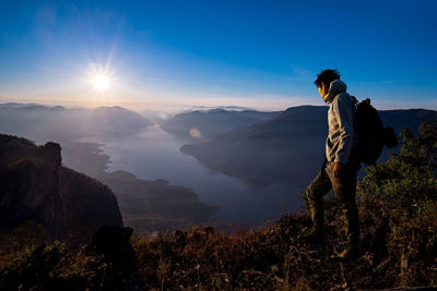 Man on mountain at sunrise