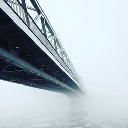 Low angle view of suspension bridge against sky