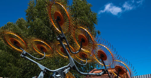 Low angle view of illuminated sculpture against sky
