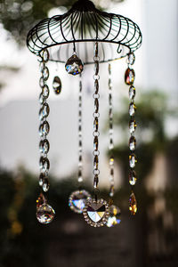 Close-up of decoration hanging on chain