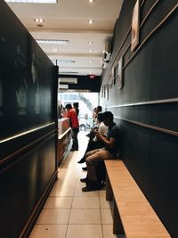 People sitting on bench in cafe