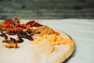 Spices and red chili peppers on table