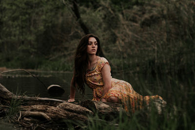 Young woman sitting on rock