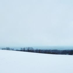 Scenic view of snow covered field against clear sky