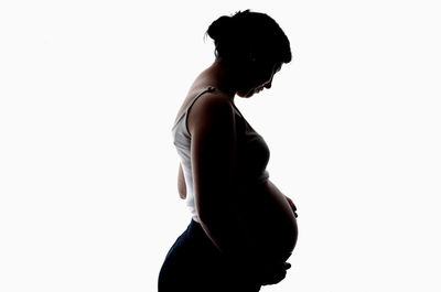 Side view of silhouette woman against white background