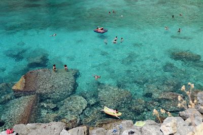 High angle view of people swimming in sea