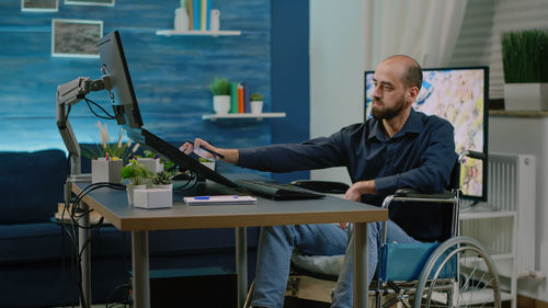 Young man using laptop at office