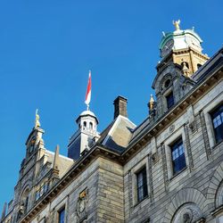 Low angle view of buildings against blue sky