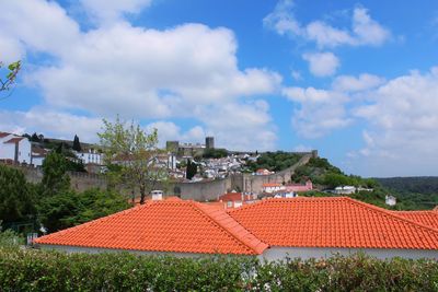 High angle view of houses in town against sky