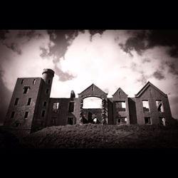 Low angle view of building against cloudy sky