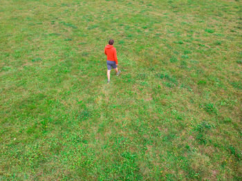 Aerial view of man walking on field