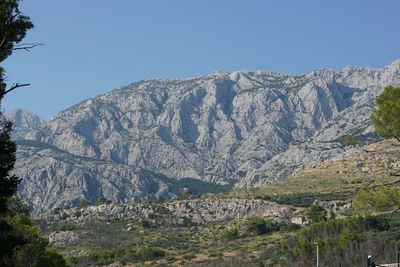 Scenic view of rocky mountains against clear blue sky