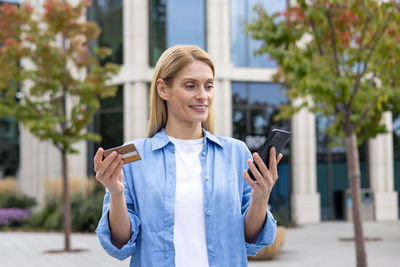 Portrait of young woman using mobile phone