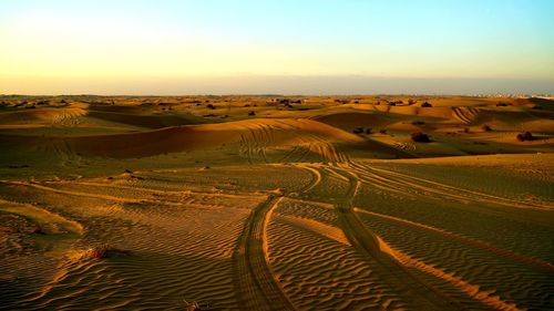 Scenic view of desert against sky during sunset