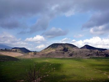 Scenic view of landscape against cloudy sky