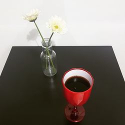 Close-up of red flower in vase on table