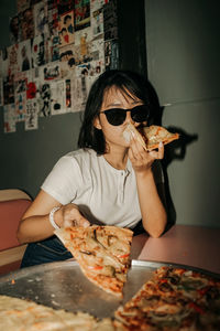 Portrait of woman having food at home