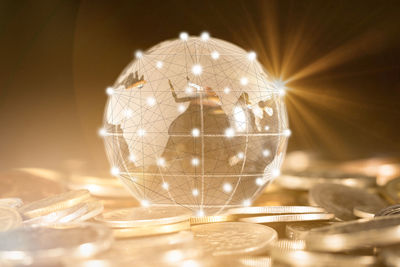 Digital composite image of globe and coins