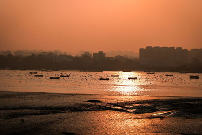 Scenic view of sea against orange sky