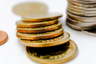 Close-up of coins over white background